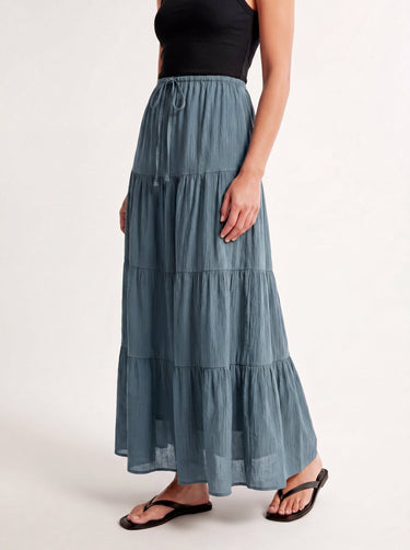Olivia A-Line Skirt in blue — tiered maxi skirt, front three-quarter view on model