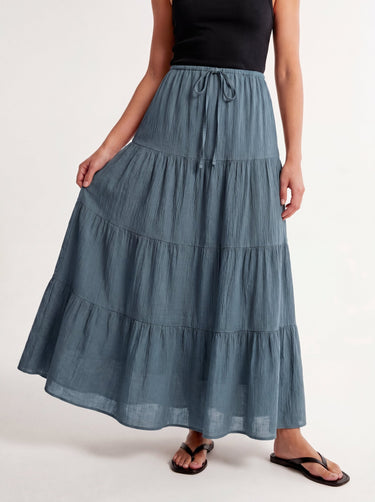 Olivia A-Line Skirt in blue — tiered maxi skirt, walking view on model