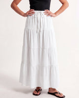Olivia A-Line Skirt in white — tiered maxi skirt, front view on model with hands on hips