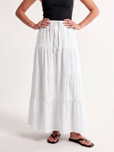 Olivia A-Line Skirt in white — tiered maxi skirt, front view on model with hands on hips