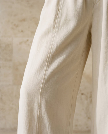 Cream wide-fit pants, fluid drape leg close-up – Moriel Heritage