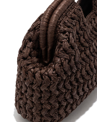 Close-up of the Ravello Woven Clutch's chunky basketweave texture and rolled handle in brown