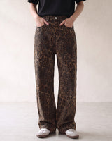 Rhea Leopard Print Jeans — mid-rise leopard-print jeans, front view on model with hands in pockets