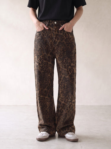 Rhea Leopard Print Jeans — mid-rise leopard-print jeans, front view on model with hands in pockets
