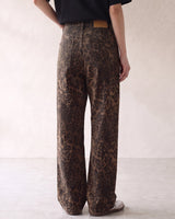 Rhea Leopard Print Jeans — back view on model showing the seat, back pockets and waistband patch
