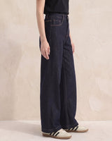 Model wearing dark denim high-rise wide-leg jeans, side view – Moriel Heritage