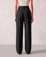 Back view of the black Riviera Tailored Pants showing the two welt back pockets and the straight wide-leg drape