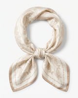 Satin Scarf in cream paisley — ivory silky scarf with taupe paisley print, tied in a knot, flat lay on white