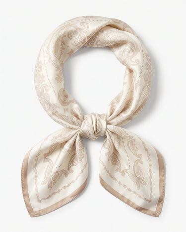 Satin Scarf in cream paisley — ivory silky scarf with taupe paisley print, tied in a knot, flat lay on white