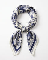 Satin Scarf in navy toile — ivory silky scarf with navy toile de jouy print, tied in a knot, flat lay on white