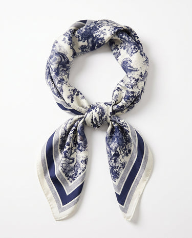 Satin Scarf in navy toile — ivory silky scarf with navy toile de jouy print, tied in a knot, flat lay on white
