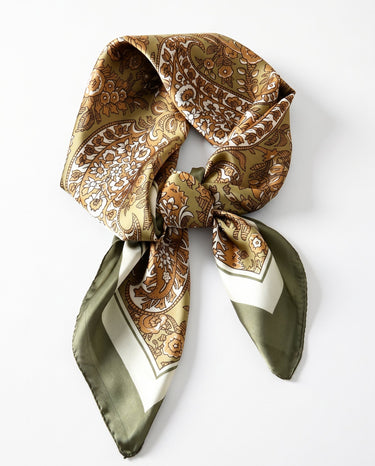 Satin Scarf in olive paisley — olive green and gold paisley print, tied in a knot, flat lay on white