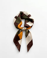 Satin Scarf in retro geometric — brown, olive and marigold colour-block print, tied, flat lay on white