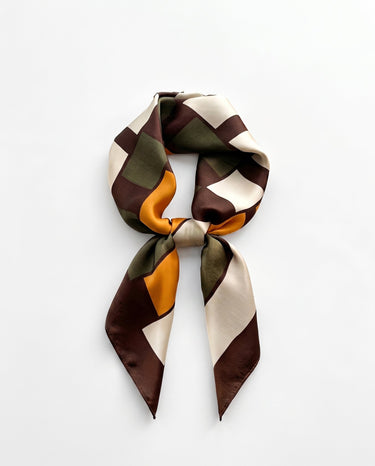 Satin Scarf in retro geometric — brown, olive and marigold colour-block print, tied, flat lay on white