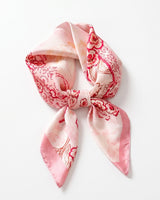 Satin Scarf in rose folk floral — pink silky scarf with red floral print, tied in a knot, flat lay on white