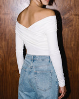 Close-up of white off-shoulder bodysuit showing crossover draped neckline from behind – Moriel Heritage