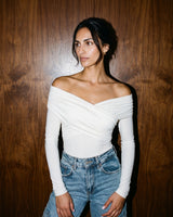 Model wearing white off-shoulder bodysuit, three-quarter front view – Moriel Heritage