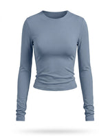Dusty blue fitted long-sleeve crew-neck top with ruched cuffs, flat-lay front view – Moriel Heritage