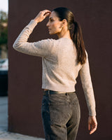 Short Knitted Cardigan in beige — back three-quarter view on model