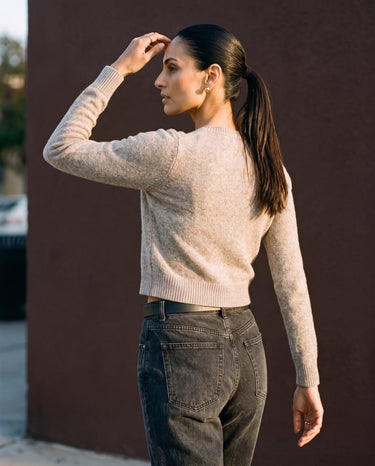 Short Knitted Cardigan in beige — back three-quarter view on model