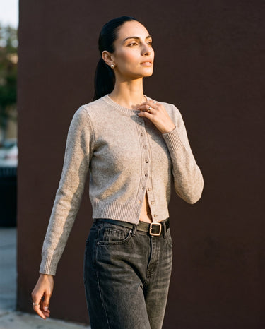 Short Knitted Cardigan in beige — front three-quarter view on model
