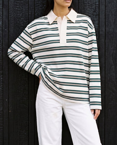 Stripe Long Sleeve Polo in green — front view on model, styled with white jeans