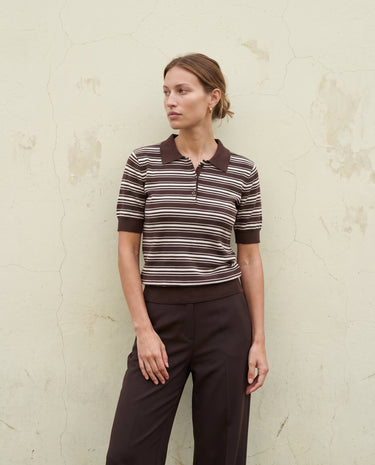 Stripe Short Sleeve Polo in cocoa — full-length front view on model against a pale wall