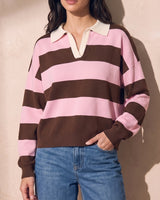 Striped Knit Polo Sweater in pink and cocoa — model with hand in jeans pocket, casual front view
