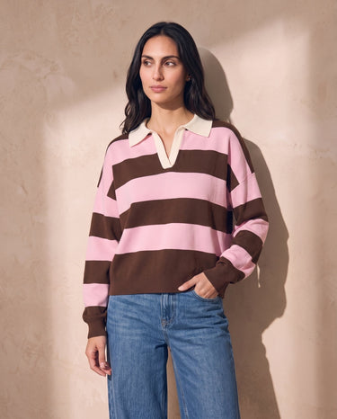 Striped Knit Polo Sweater in pink and cocoa — model with hand in jeans pocket, casual front view