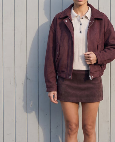 Model wearing the burgundy suede-look bomber jacket zipped low, front view