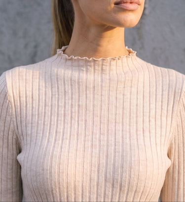 Sylvie Body Suit in white — close-up of the ruffled mock neckline