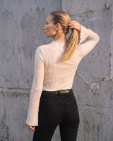 Sylvie Body Suit in white — back three-quarter view on model