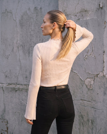 Sylvie Body Suit in white — back three-quarter view on model