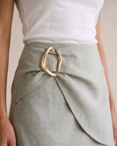 The Ainsley Buckle Skort in light sage gray — close-up of gold ring buckle at the wrapped waist