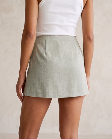 The Ainsley Buckle Skort in light sage gray — side view of the skort on model