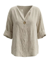 The Aire Relaxed Shirt in beige — relaxed V-neck long-sleeve shirt with wood button front, product flat-lay