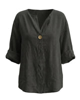 The Aire Relaxed Shirt in black — relaxed V-neck long-sleeve shirt with wood button front, product flat-lay