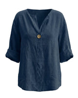 The Aire Relaxed Shirt in navy — relaxed V-neck long-sleeve shirt with wood button front, product flat-lay