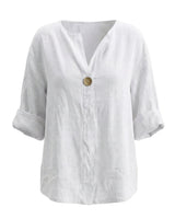 The Aire Relaxed Shirt in white — relaxed V-neck long-sleeve shirt with wood button front, product flat-lay