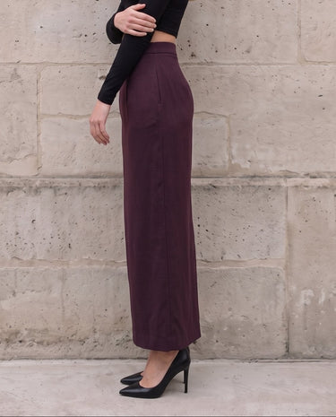 The Aisla Burgundy Skirt in burgundy — high-waisted straight maxi skirt, side view on model