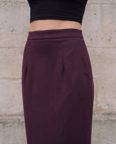The Aisla Burgundy Skirt in burgundy — close-up of the high waistband and front pleats