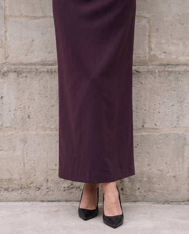 The Aisla Burgundy Skirt in burgundy — close-up of the skirt hem and back