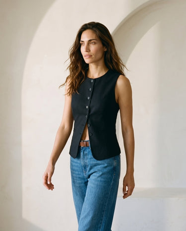 The Alicia vest in black — front three-quarter view on model