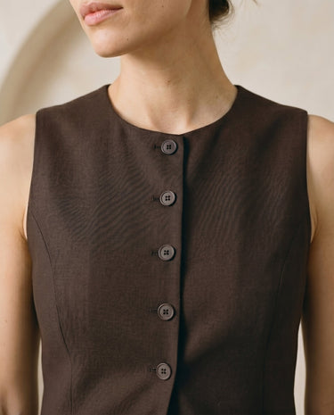 The Alicia vest in brown — close-up of the neckline and button front