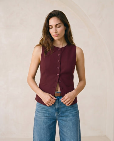 The Alicia vest in burgundy — front view on model