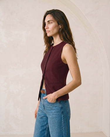 The Alicia vest in burgundy — back three-quarter view on model