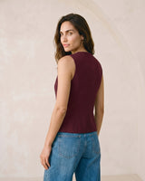 The Alicia vest in burgundy — side profile view on model