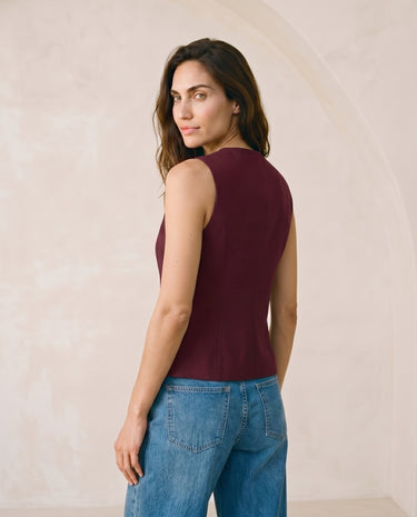 The Alicia vest in burgundy — side profile view on model