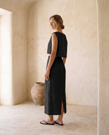 The Alora Linen Blend Set in black — linen-blend top and maxi skirt, side view on model