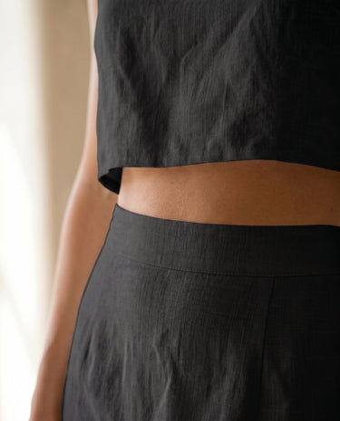 The Alora Linen Blend Set in black — close-up of skirt waistband and cropped top hem
